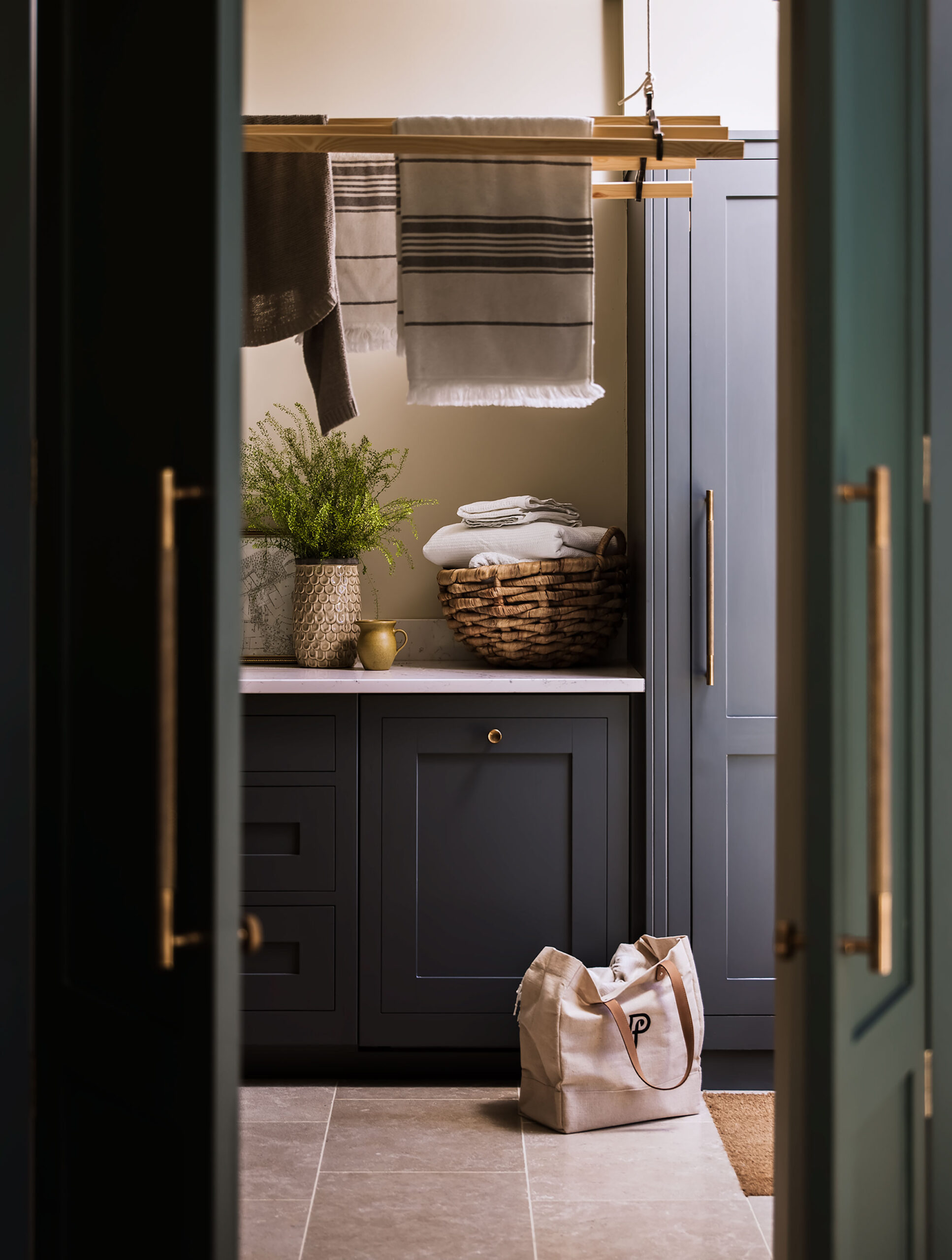 Dark utility room cabinetry seen through open door