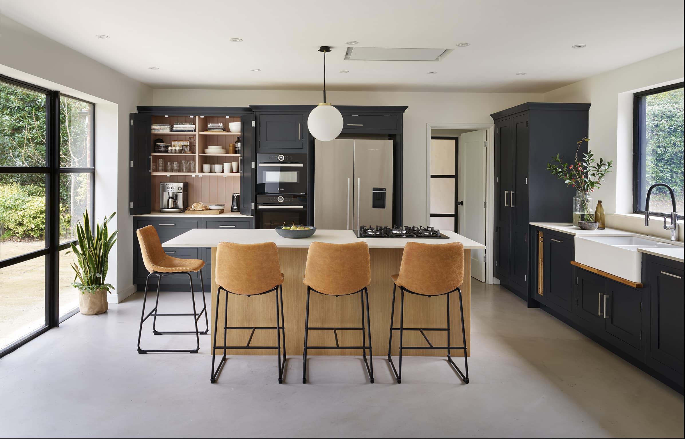Dark Shaker kitchen cabinetry with light oak kitchen island with light grey worktops