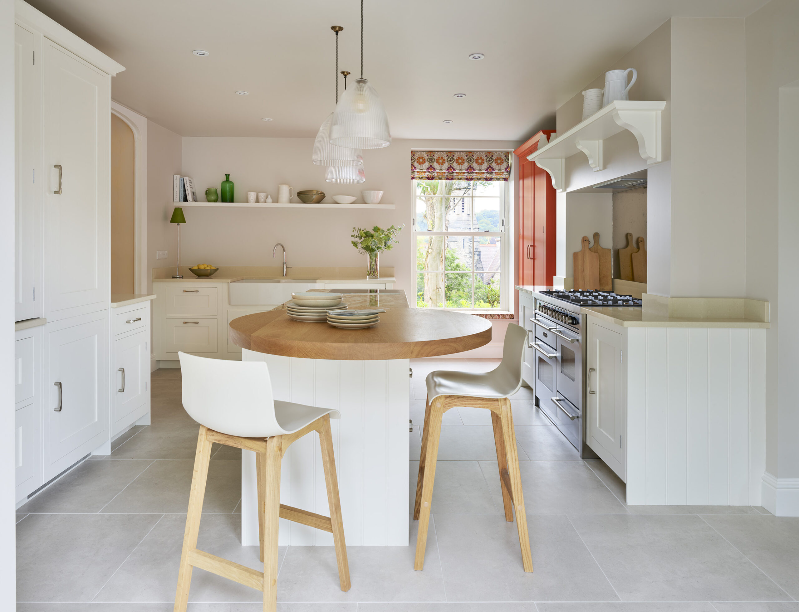 Shaker kitchen design featuring white kitchen cabinetry and orange pantry