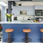 Blue Shaker kitchen design featuring rich blue kitchen island and pale blue painted cabinetry