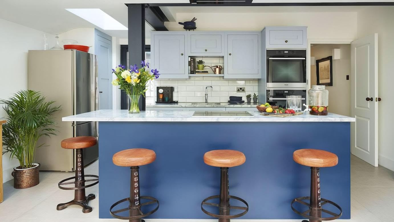 Blue Shaker kitchen design featuring rich blue kitchen island and pale blue painted cabinetry