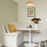 Corner dining area featuring white banquette seating