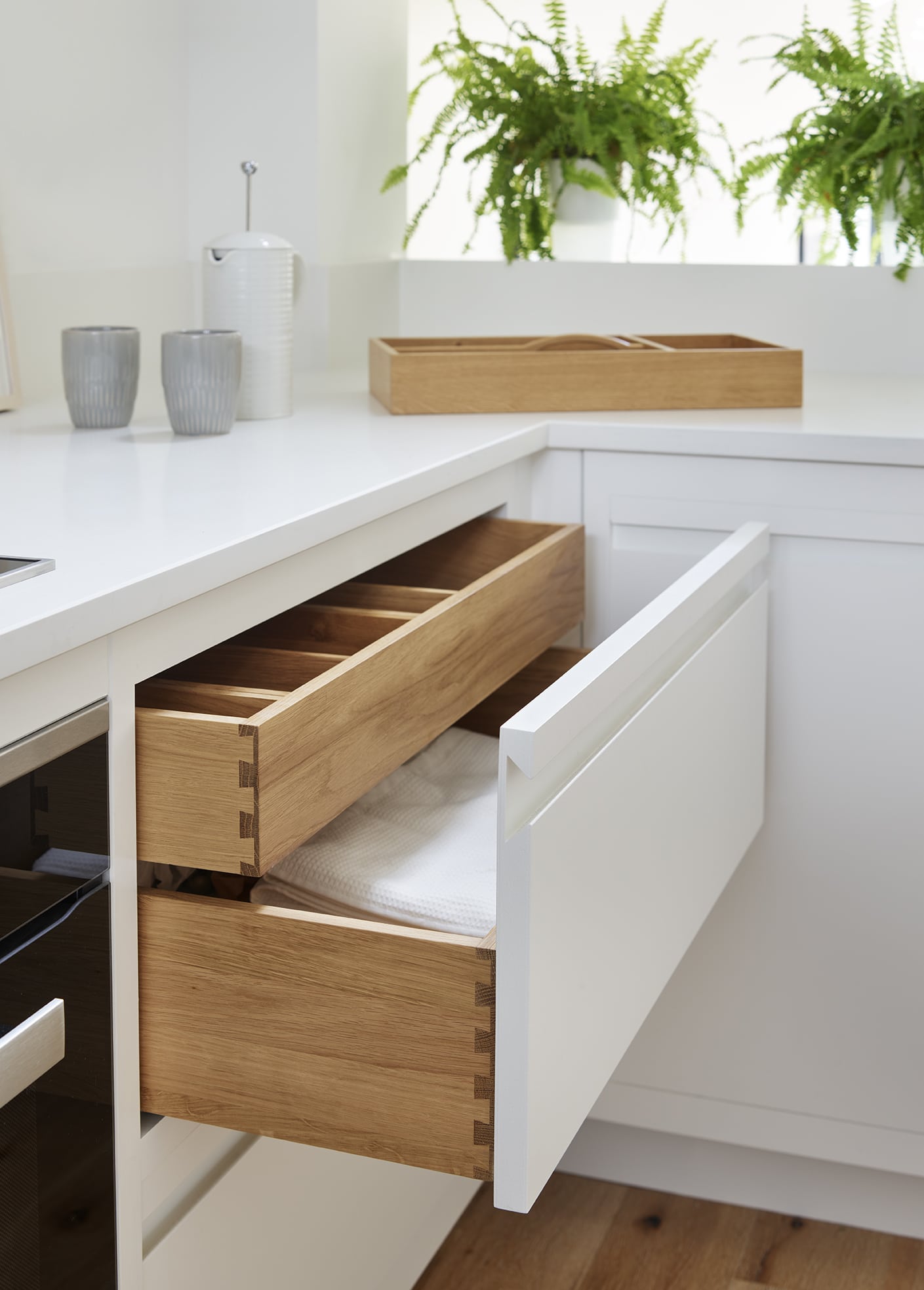 White Linear Edge kitchen draws open to reveal natural oak lining