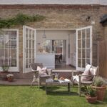 External view of white Original kitchen seen through open white French doors
