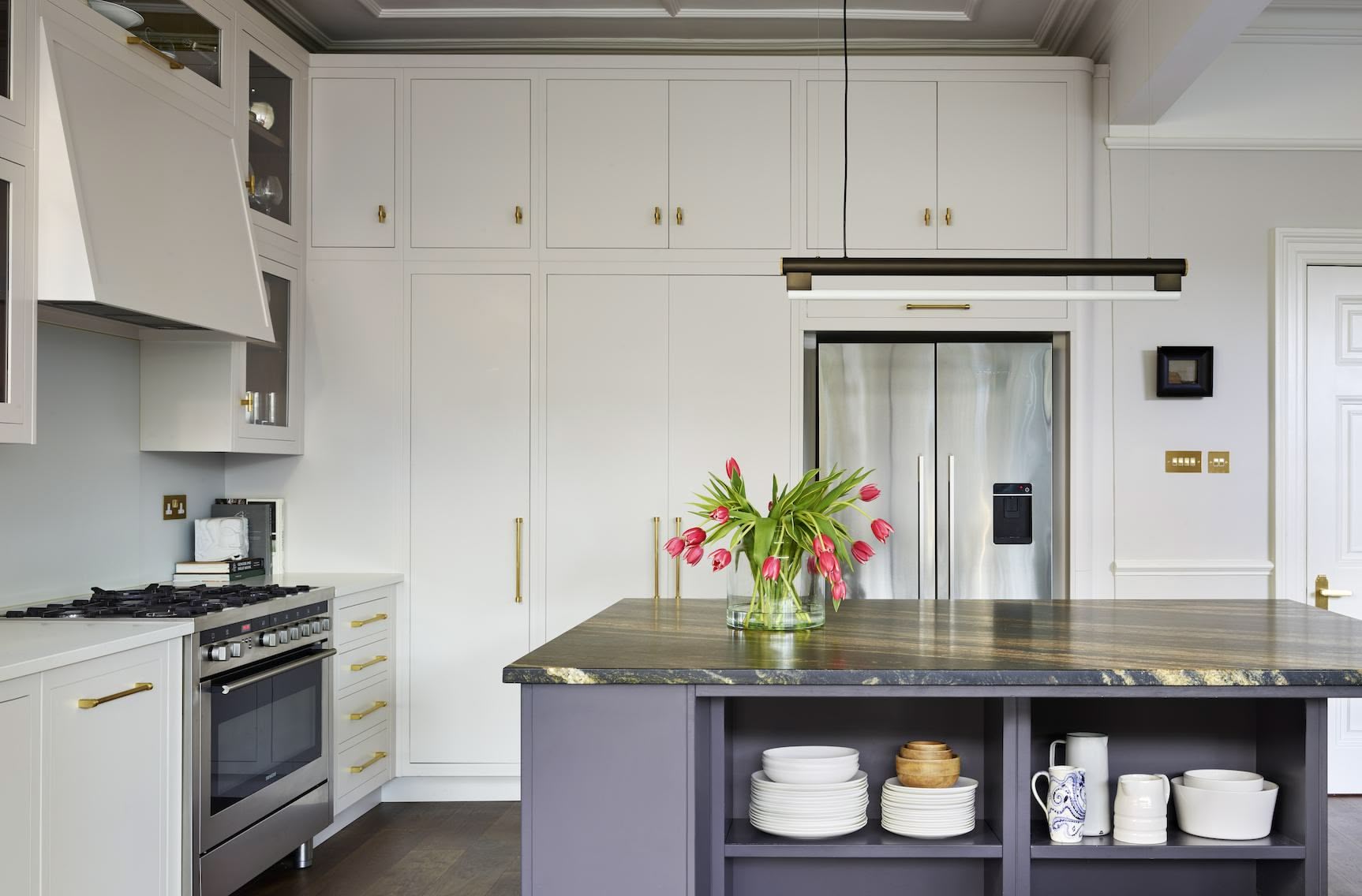 White Linear kitchen cabinetry and blue kitchen island with organised shelving