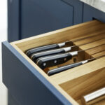 Closeup of blue Shaker drawer with light oak interior