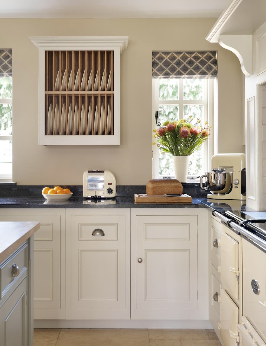 White open shelving kitchen cabinetry with open plate rack
