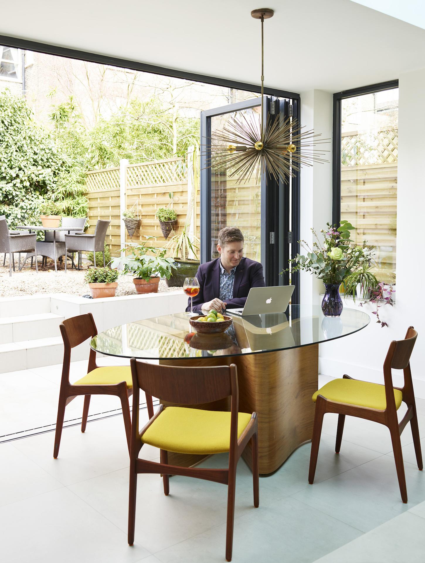 Open plan dining area with glass wall door