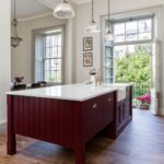 Burgundy kitchen island with white marble worktop