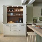 Harvey Jones off-white kitchen dresser open to show organised shelving
