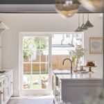 White Original kitchen design with open white French doors