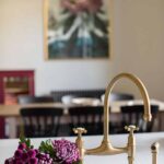 White basin kitchen sink with gold tap
