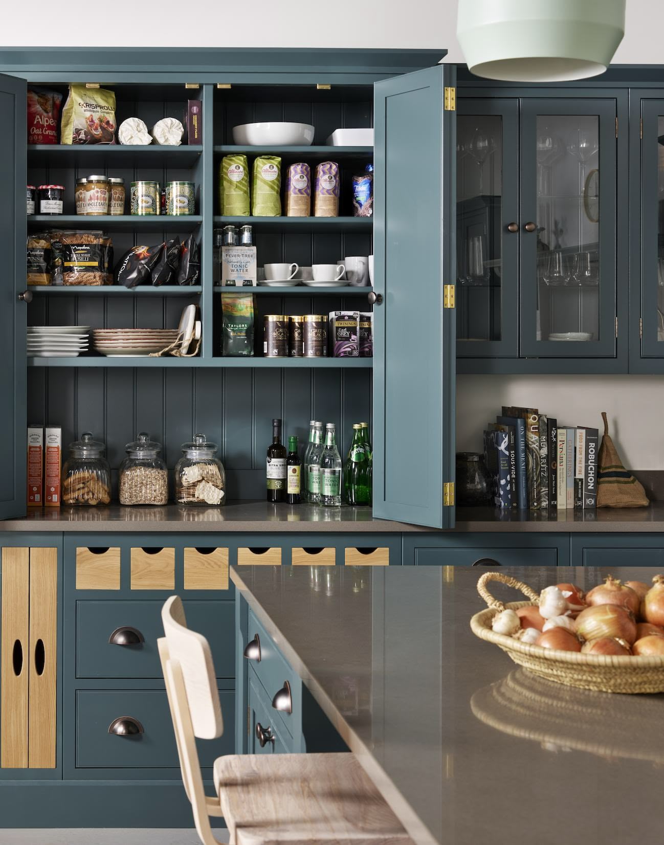 Harvey Jones green kitchen dresser open to show organised shelving