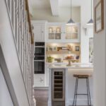 White kitchen island with wine fridge