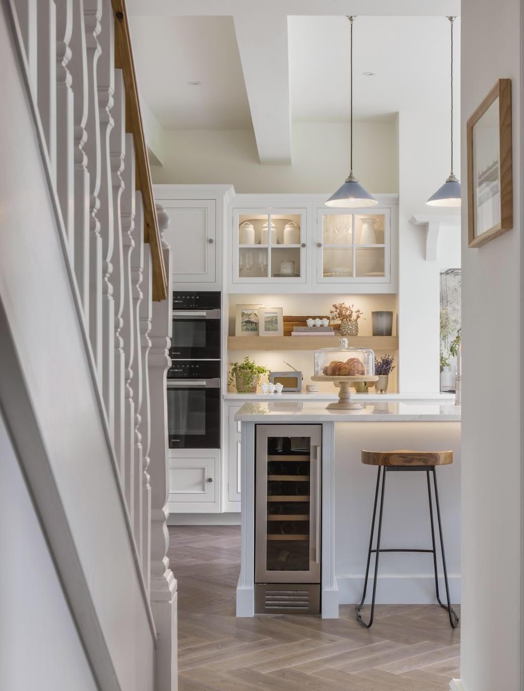 White kitchen island with wine fridge