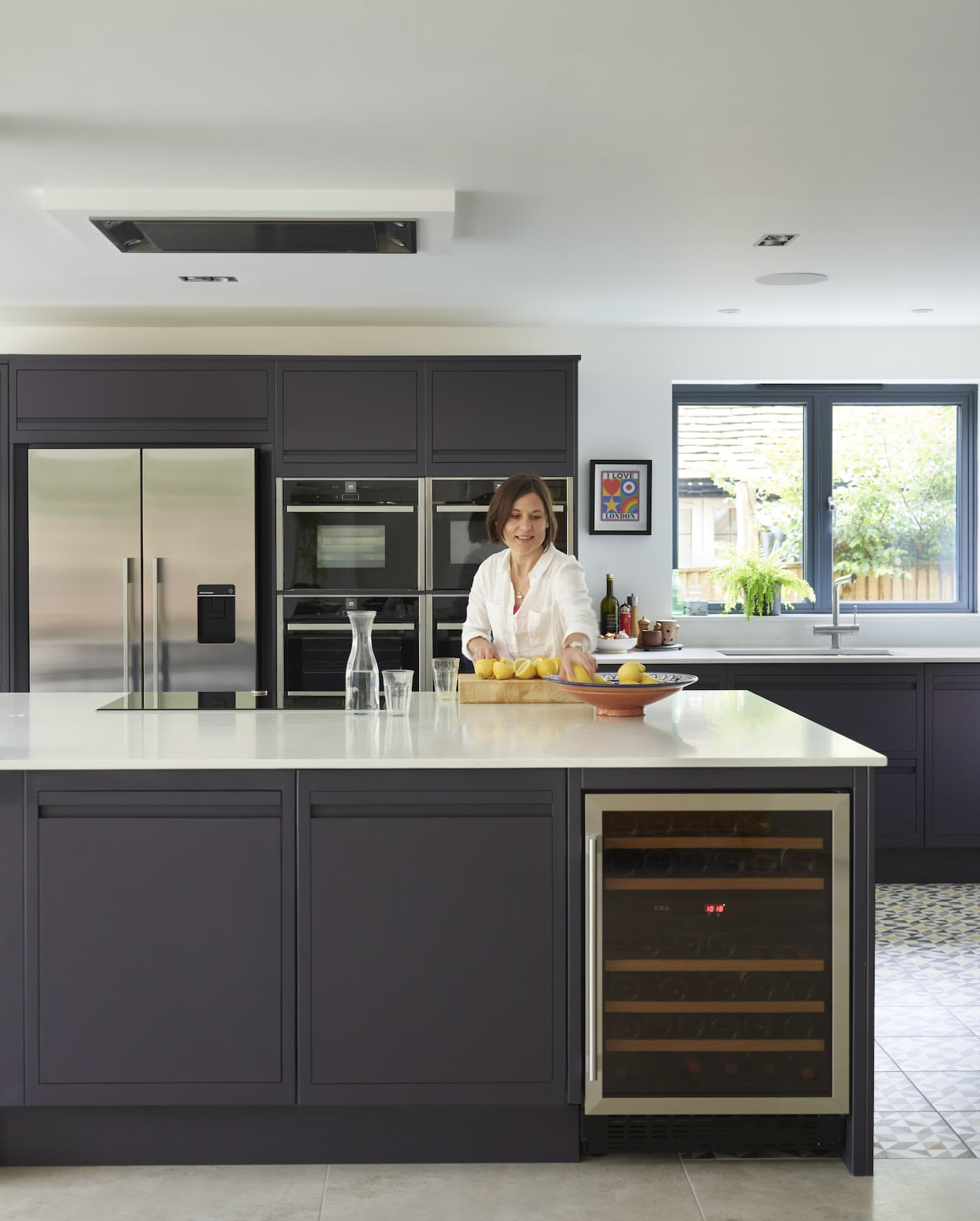 Dark grey kitchen island with wine fridge