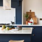 Deep blue Arbor kitchen island and cabinetry with white worktops