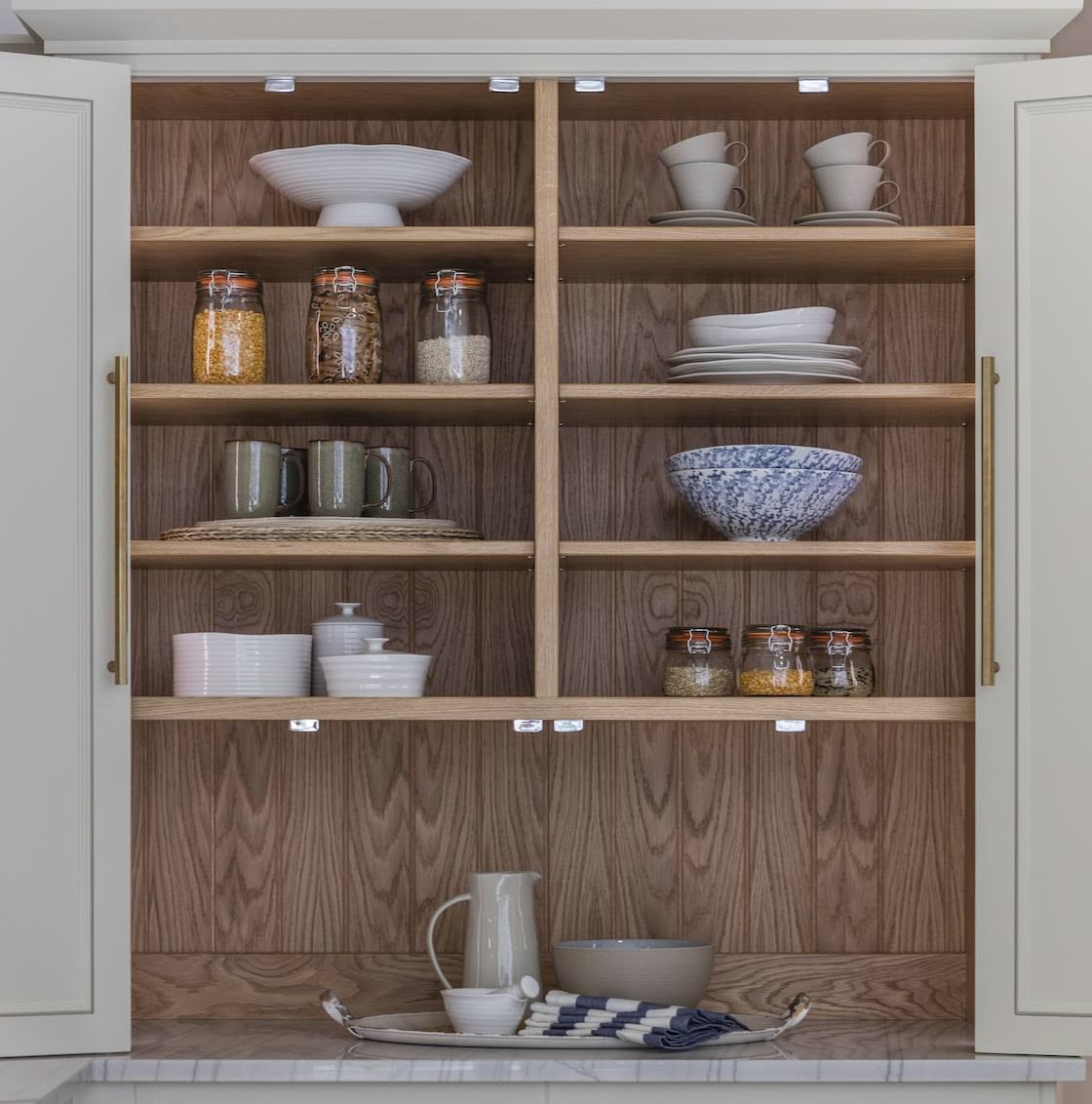 Harvey Jones white kitchen dresser open to show organised shelving