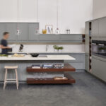 Natural wooden smile stools against grey kitchen island