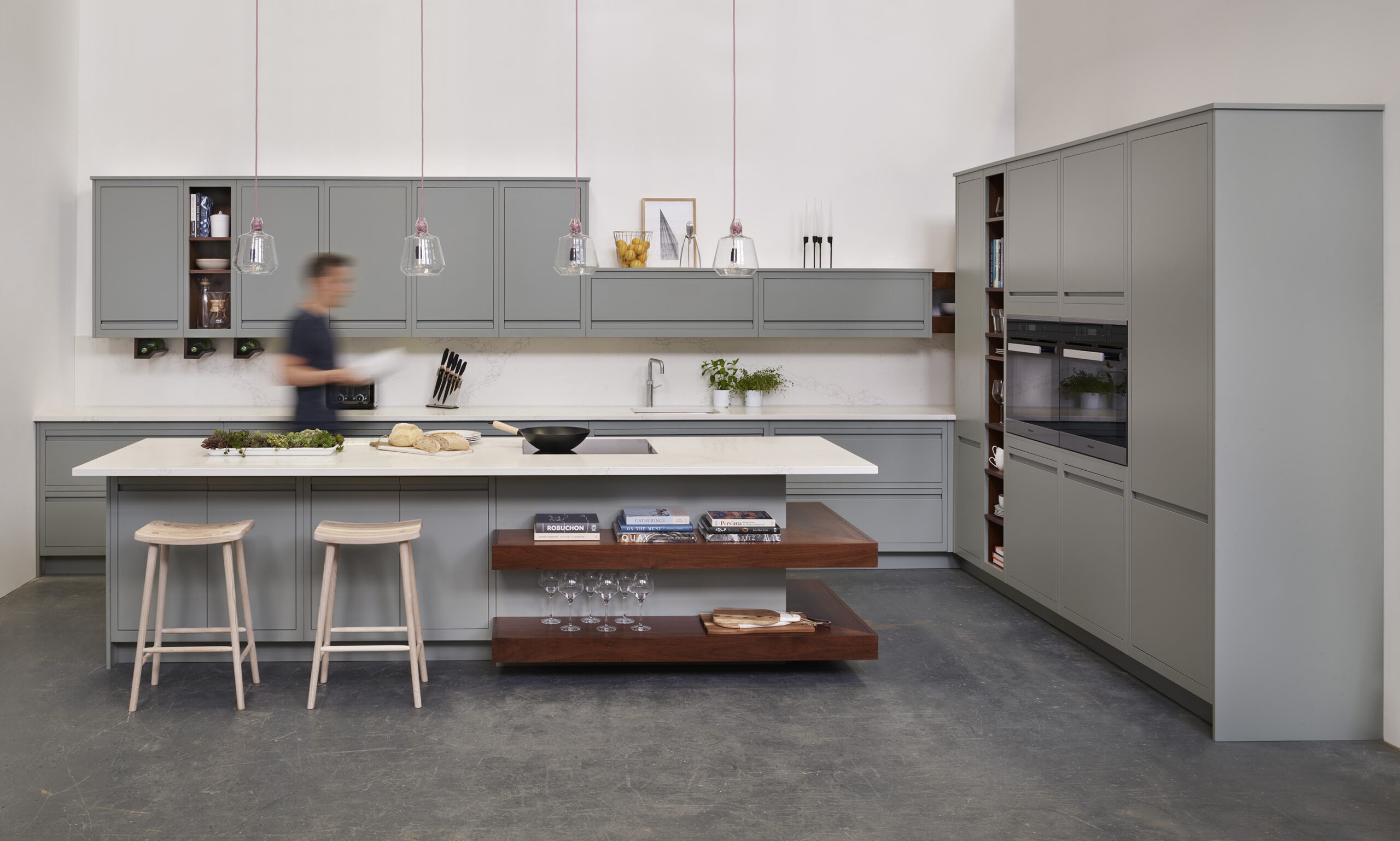 Natural wooden smile stools against grey kitchen island