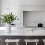 Grey Shaker kitchen island with white worktop and integrated sink featuring silver tap