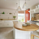 Shaker kitchen design featuring white kitchen cabinetry and orange pantry