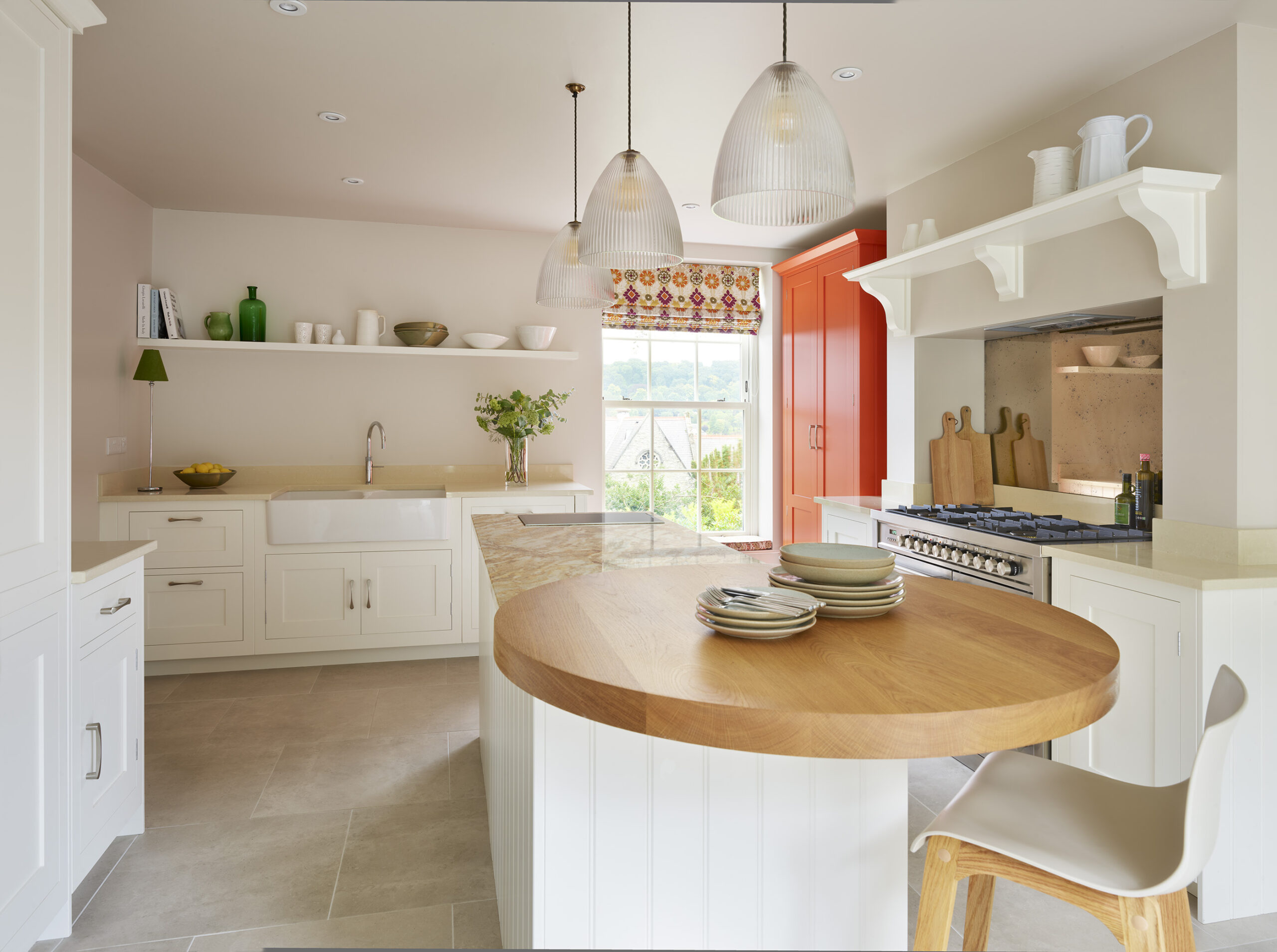 Shaker kitchen design featuring white kitchen cabinetry and orange pantry
