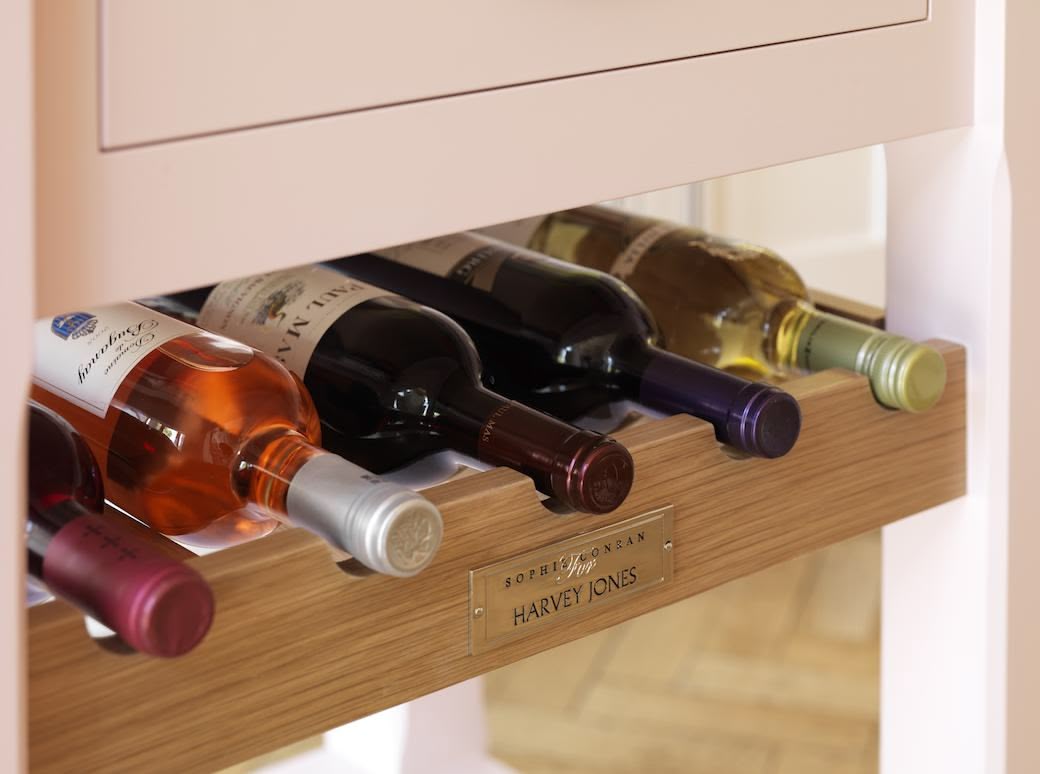 closeup of oak wine rack underneath kitchen cabinet