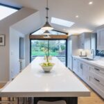 White Shaker kitchen cabinetry with white worktops