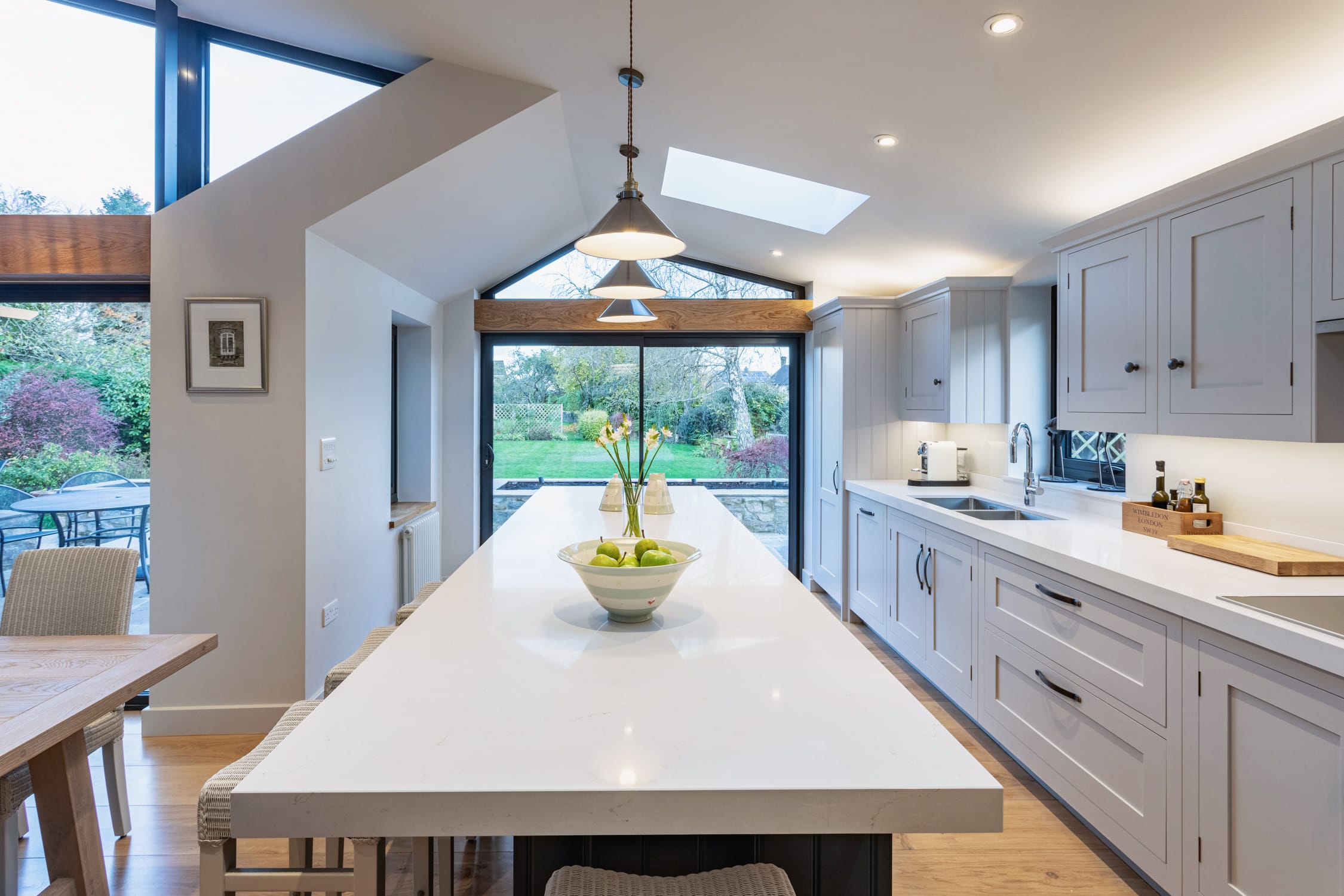 White Shaker kitchen cabinetry with white worktops