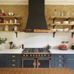 Oak open shelving against an exposed brick wall
