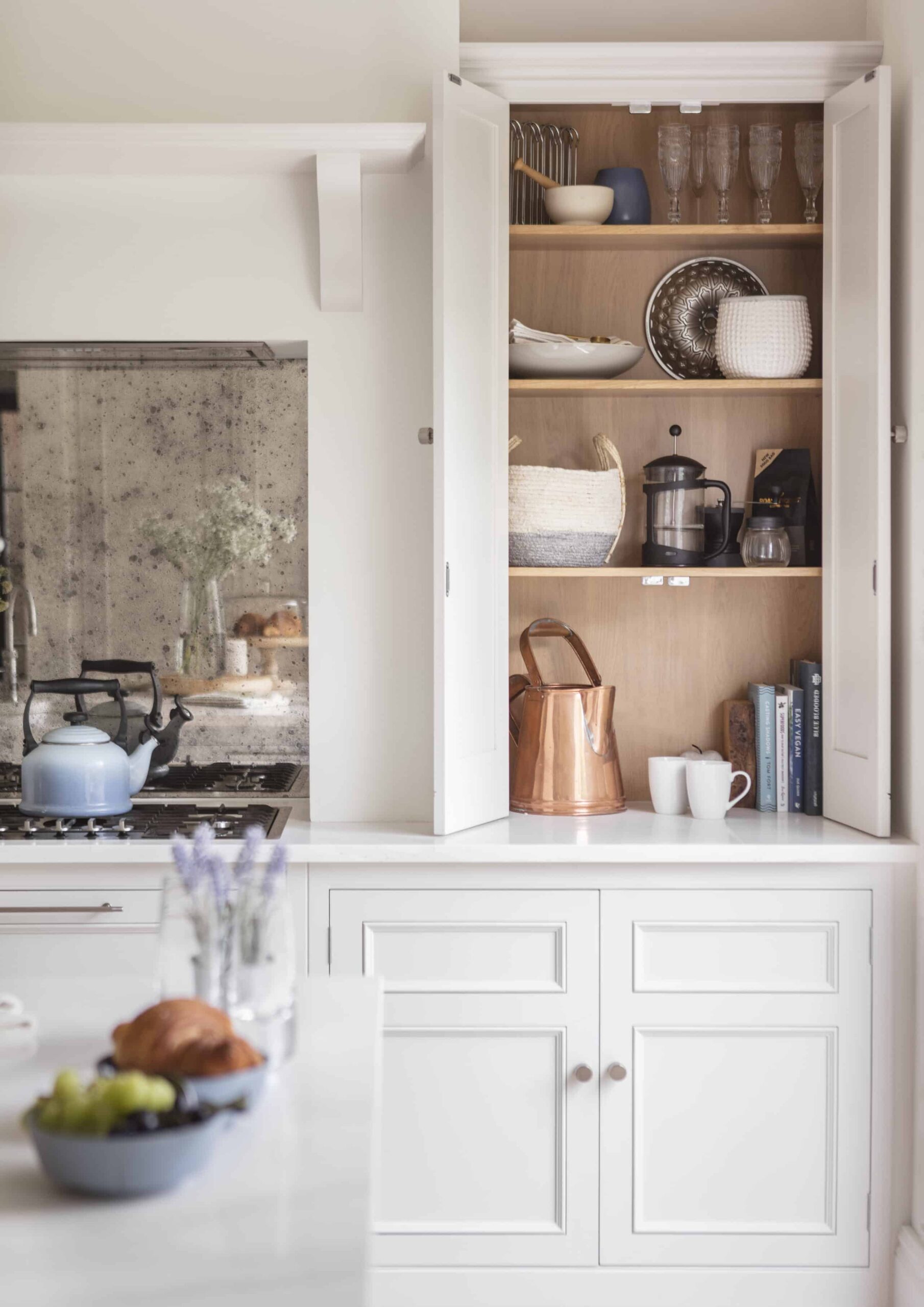 White Original kitchen cabinetry open to reveal organised storage