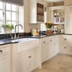 White kitchen Original cabinetry with black worktops