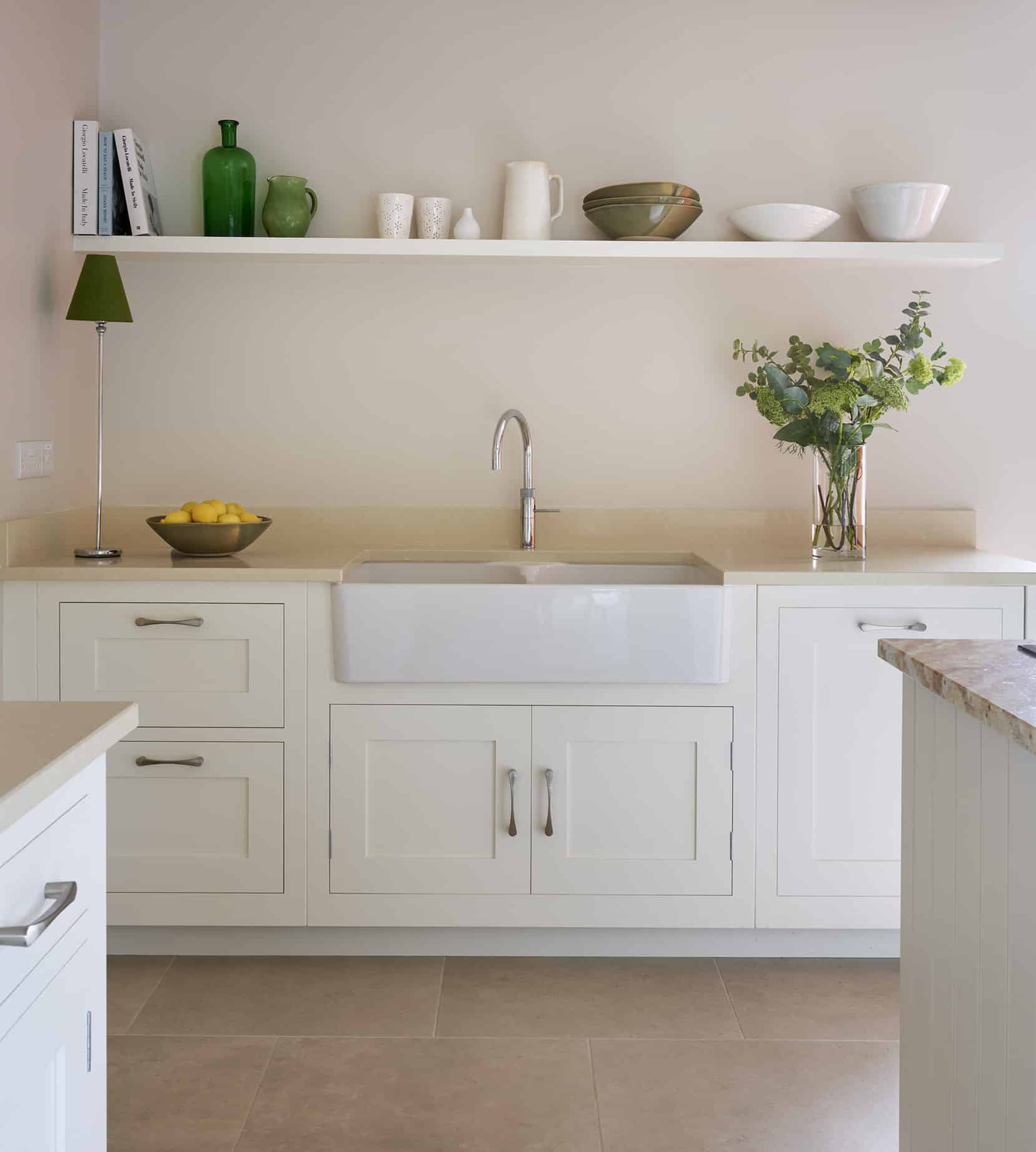 White Shaker kitchen cabinetry with cream worktop and white basin sink