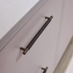 Closeup of soft pink Linear kitchen drawers with dark brown handles
