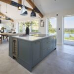 Grey kitchen island in front of an open plan dining area