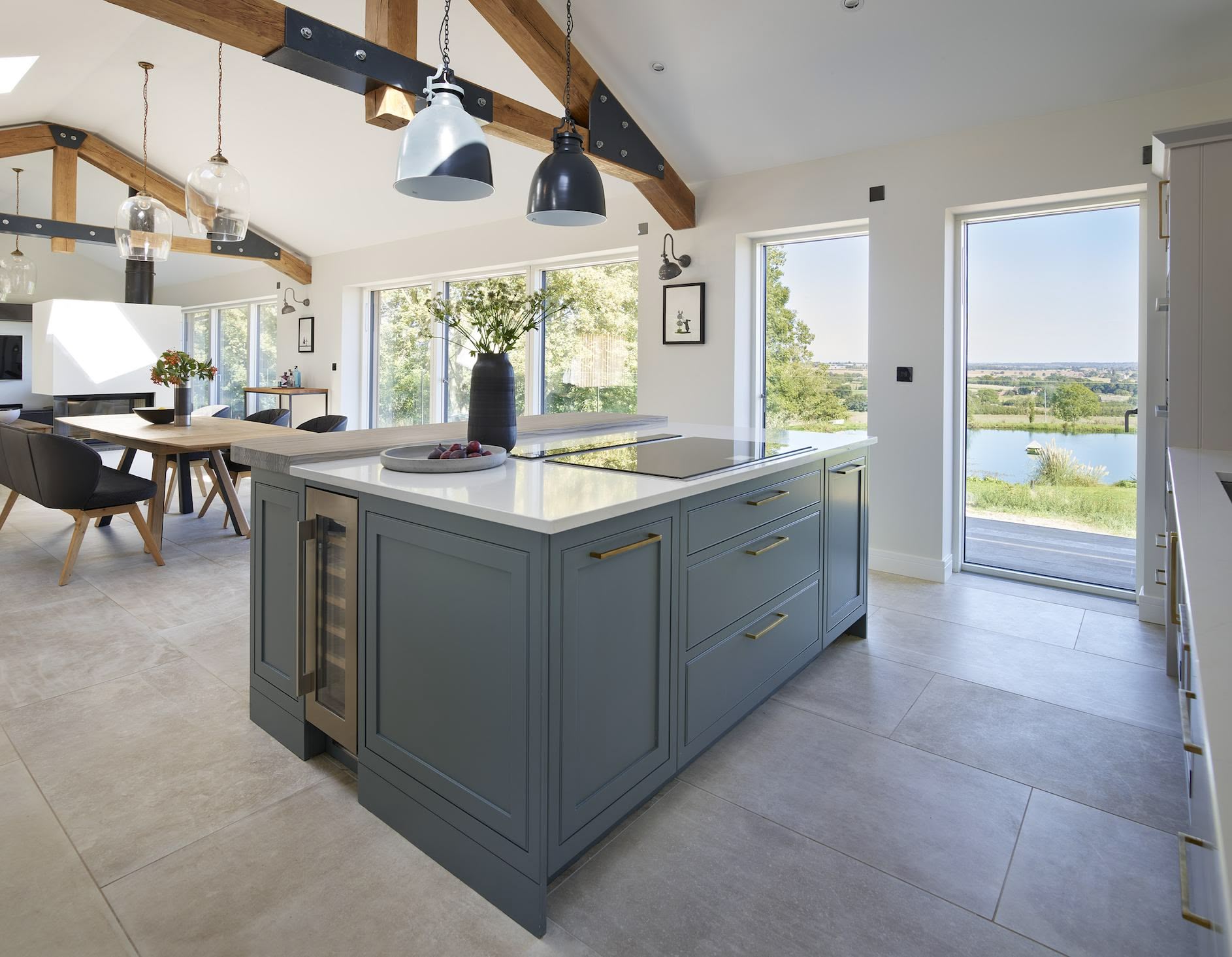Grey kitchen island in front of an open plan dining area