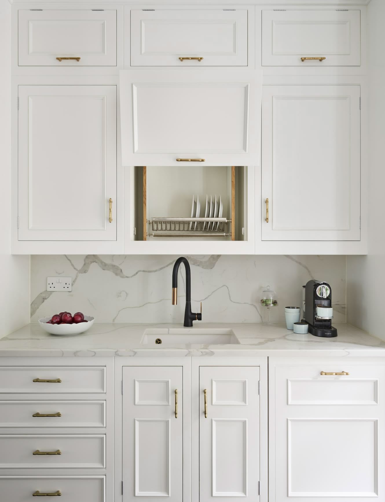 White kitchen cabinetry with open plate rack