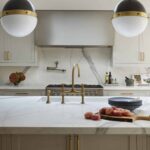 Soft grey kitchen island with integrated sink and gold tap