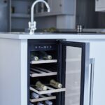 White kitchen island with wine fridge