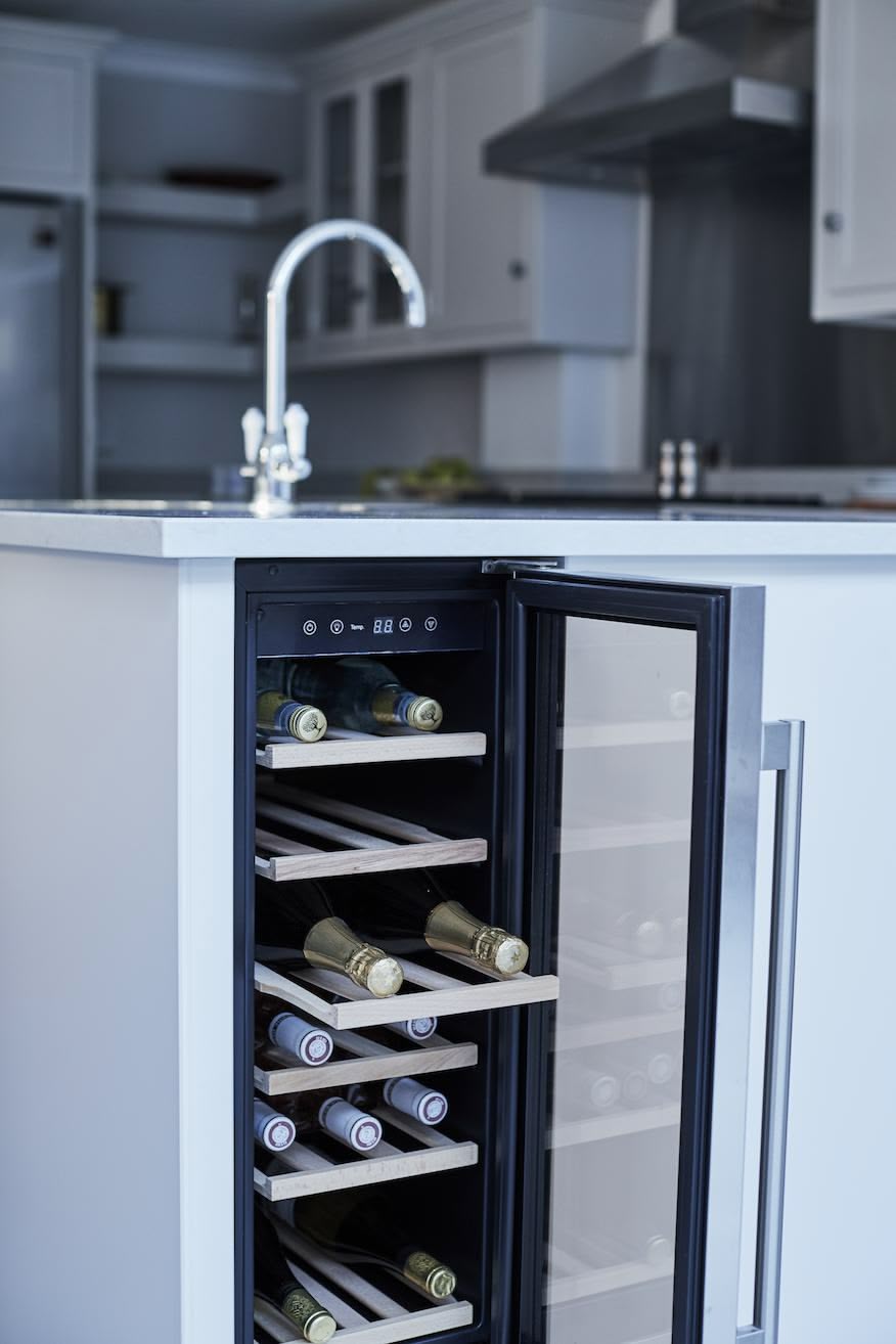 White kitchen island with wine fridge
