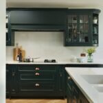 Vibrant green Original design kitchen cabinetry with brass handles and white worktops