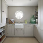 White utility room cabinetry featuring white basin sink