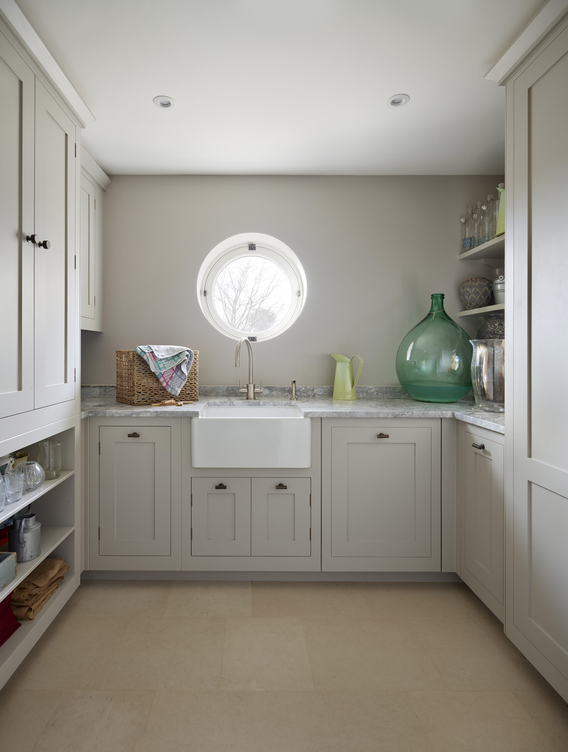 White utility room cabinetry featuring white basin sink