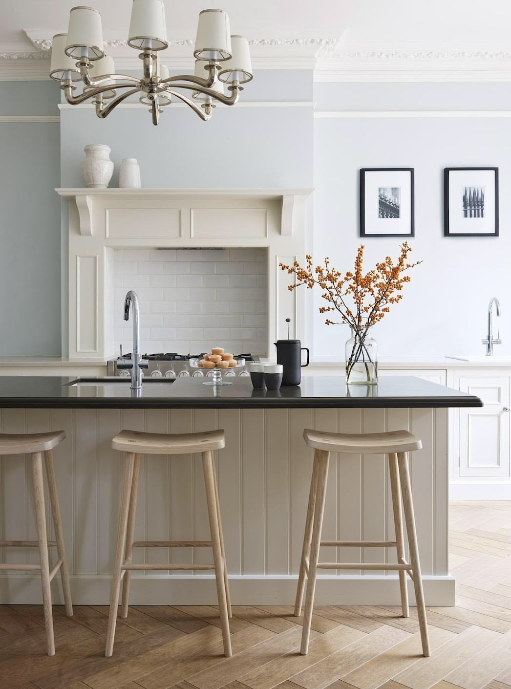 Smile stools against a white kitchen island with black worktop