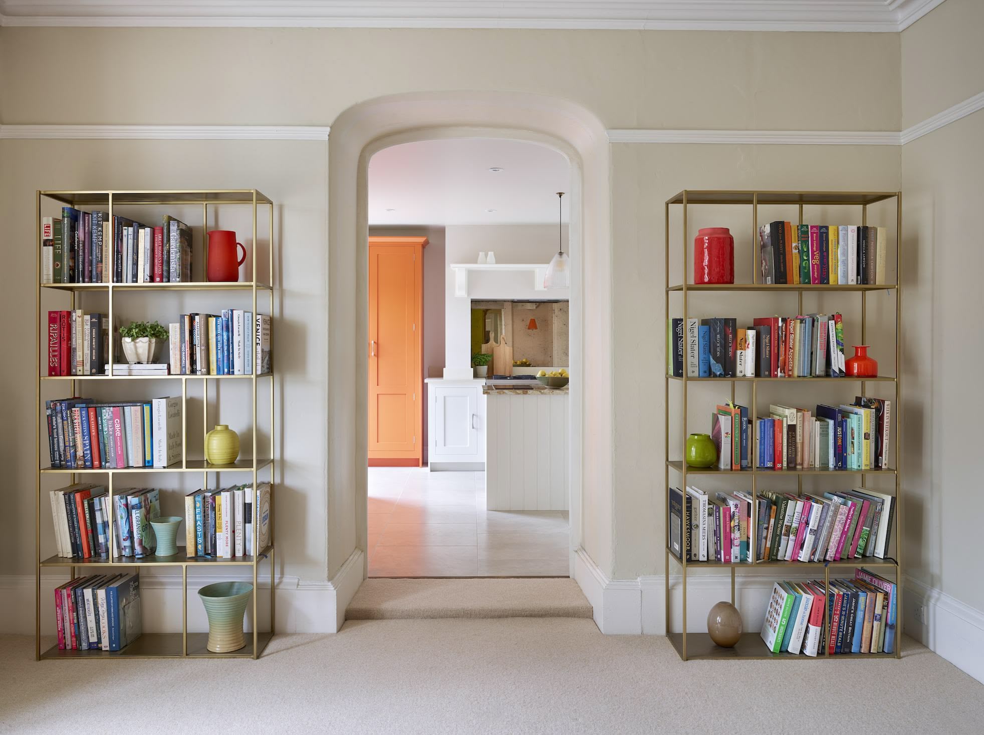 Orange Shaker pantry seen from living room archway