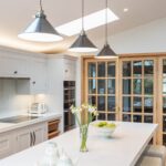 White kitchen island worktop featuring white bar stools and white Shaker kitchen cabinetry
