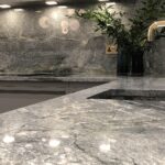 Green-grey marble worktop and sink with brass tap