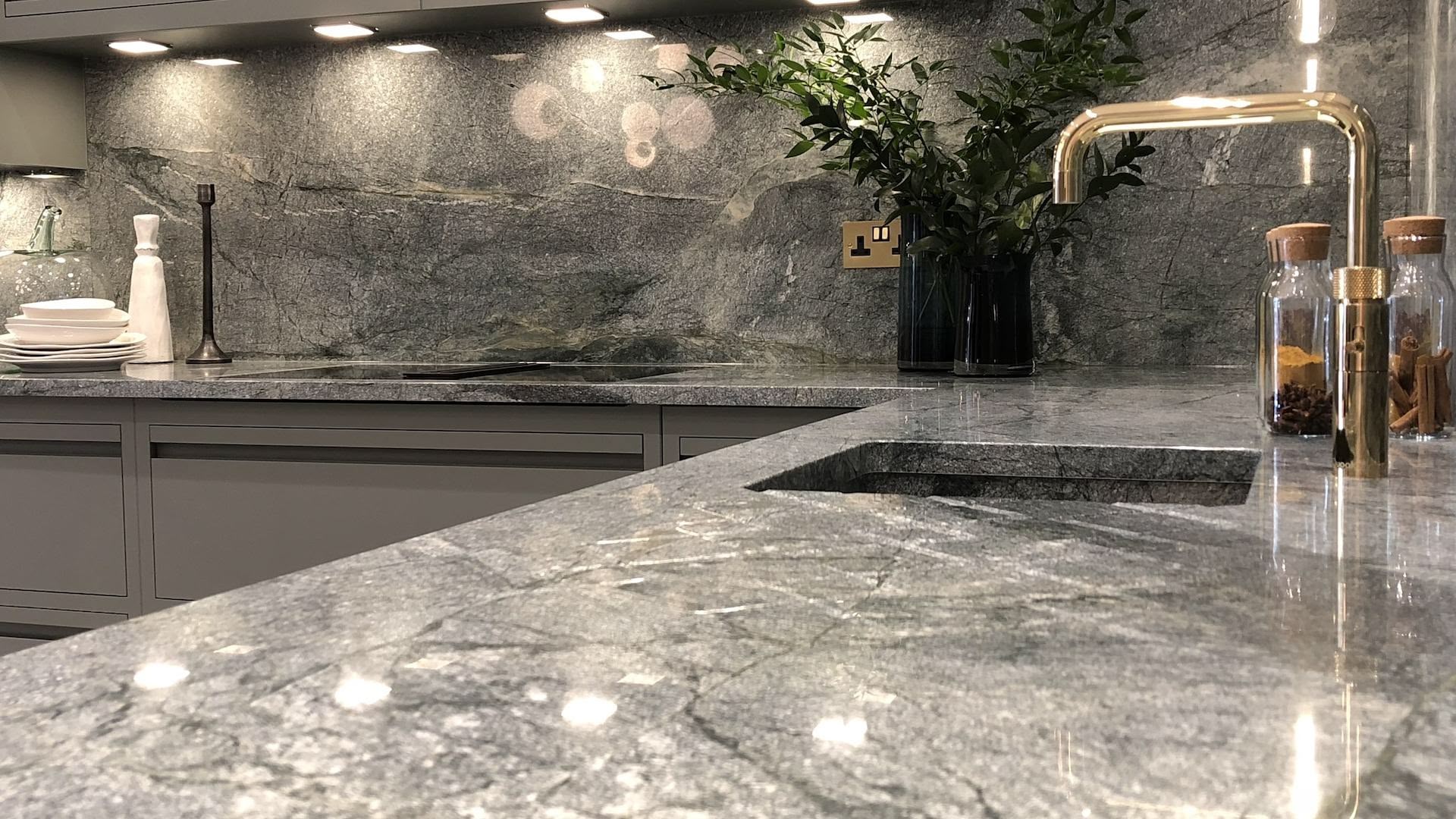 Green-grey marble worktop and sink with brass tap
