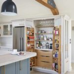 Open large pantry doors showing organised storage and drawers